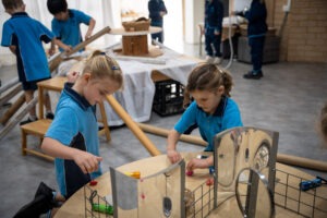 K-2 students engaging with natural materials in the South Coast Baptist College Reggio Emilia atelier.