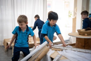 K-2 students engaging with natural materials in the South Coast Baptist College Reggio Emilia atelier.