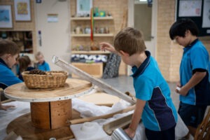 K-2 students engaging with natural materials in the South Coast Baptist College Reggio Emilia atelier.