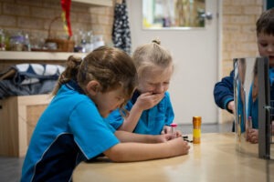 K-2 students engaging with natural materials in the South Coast Baptist College Reggio Emilia atelier.
